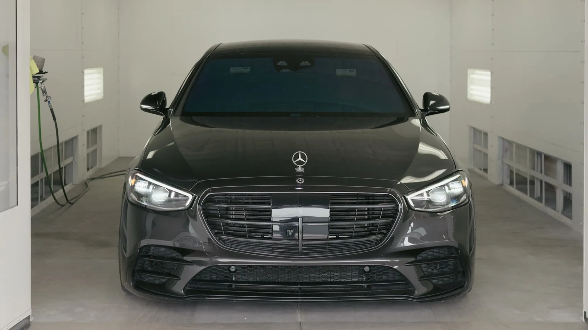 Mercedes sedan in the spray booth
