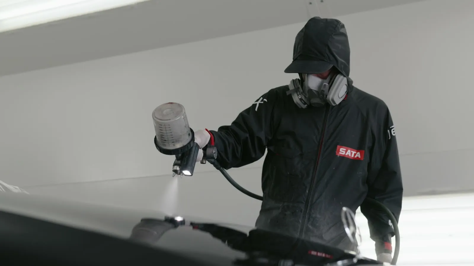 Royal Armor technician spraying Peel Clear in the Scottsdale booth