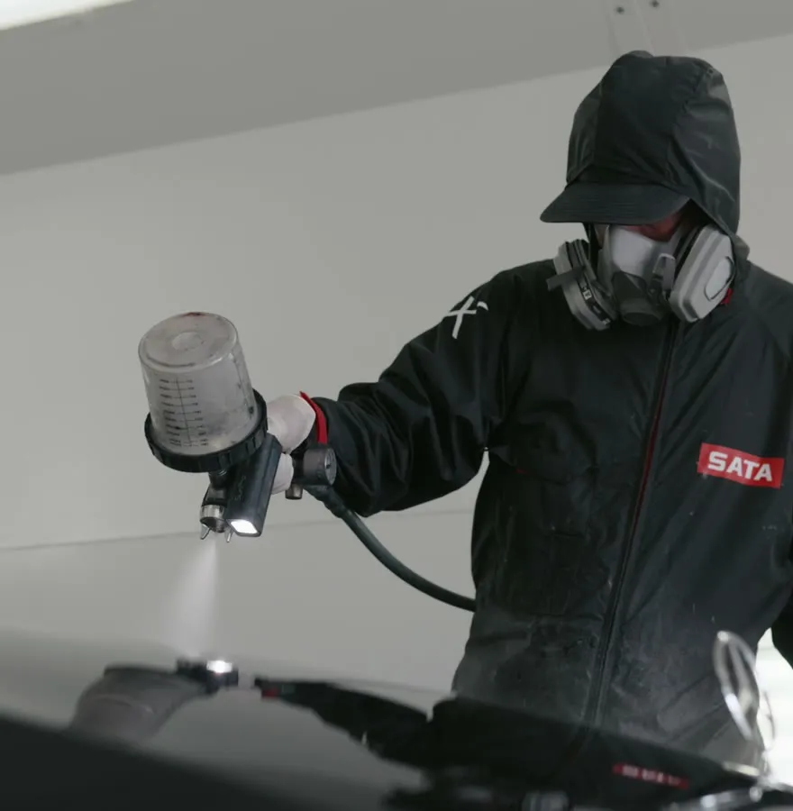 Close-up of Peel Clear being sprayed onto a vehicle panel
